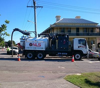 A nls truck is parked on the side of the road