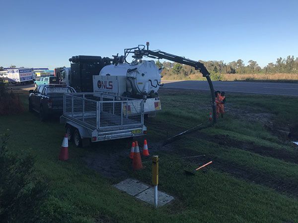 A vacuum truck is being used to clean a drain.