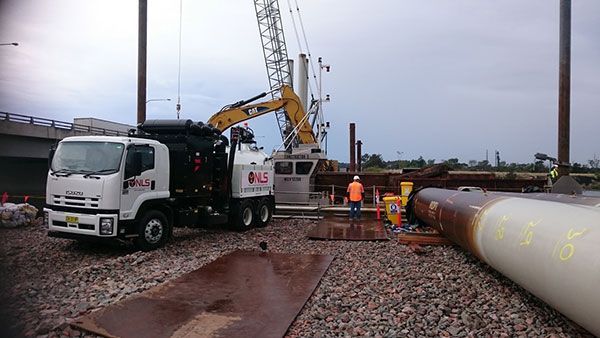 A construction site with a truck and a crane.