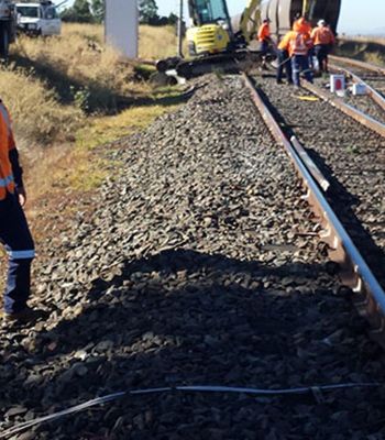A group of people are working on a train track