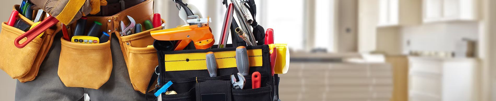 A person wearing a tool belt filled with various construction tools stands in a room under renovation.