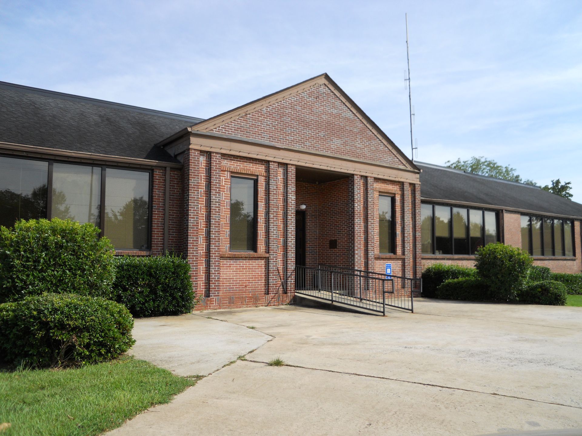 A large brick building with a handicap ramp in front of it