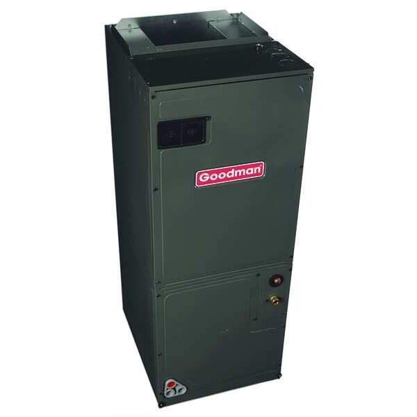 A goodman air conditioner is sitting on a white surface.