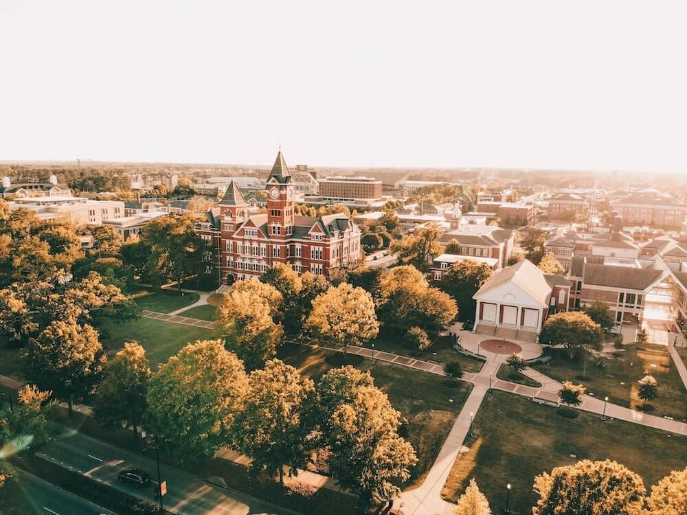 An aerial view of a city with lots of buildings and trees.