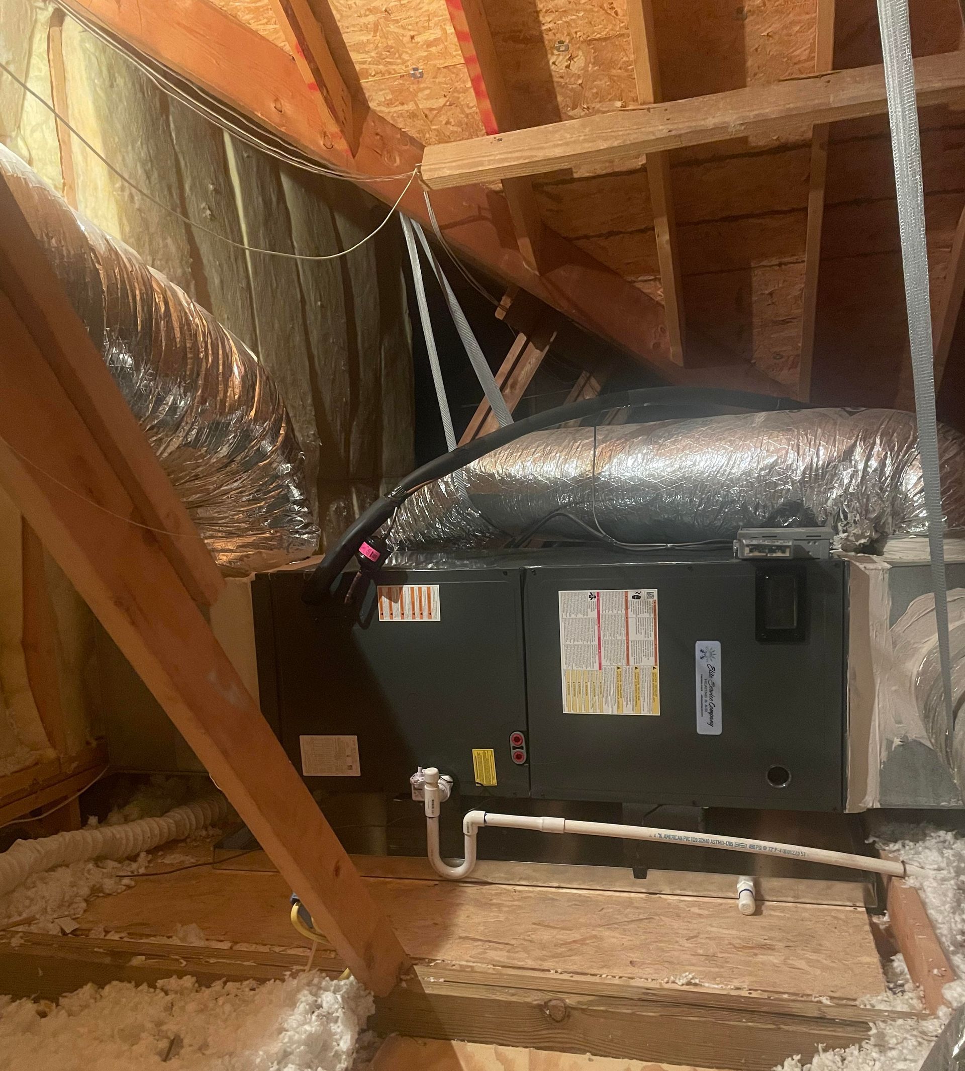 An air conditioner is installed in the attic of a house.