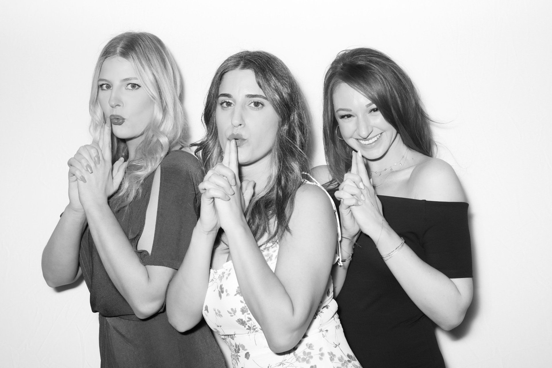 Three women are standing next to each other and making a charlies angels pose