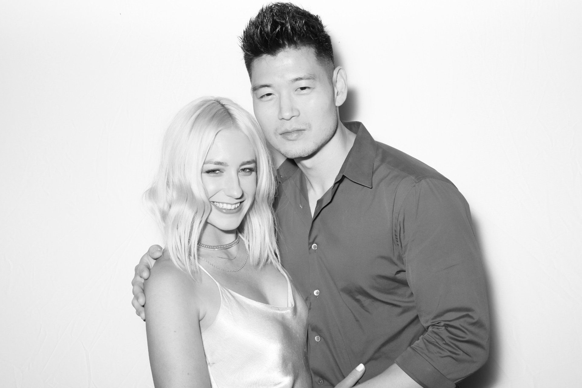 A black and white photo of a man and a woman posing for a picture in our photo booth