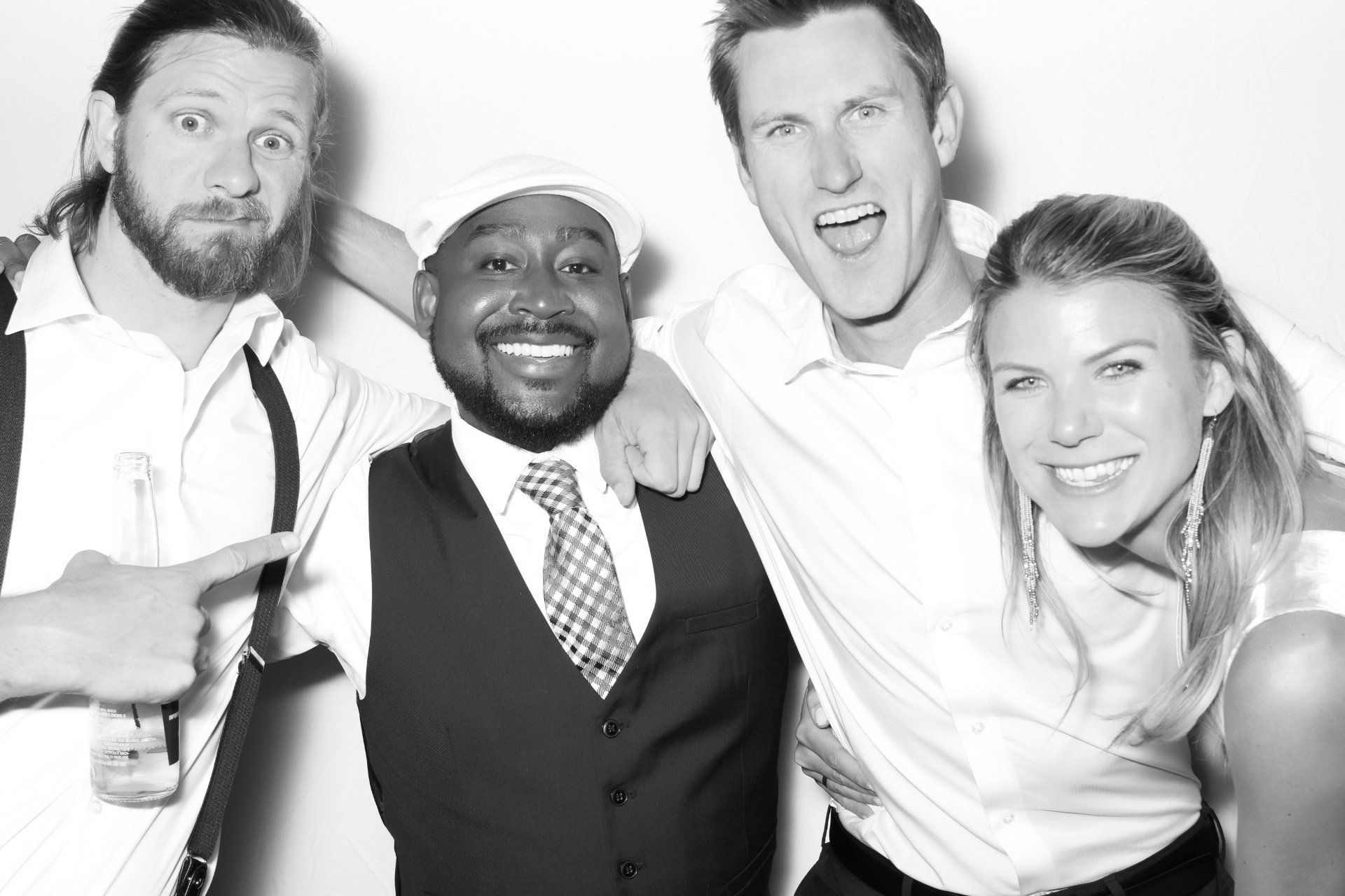 A group of people are posing for a picture in a photo booth.
