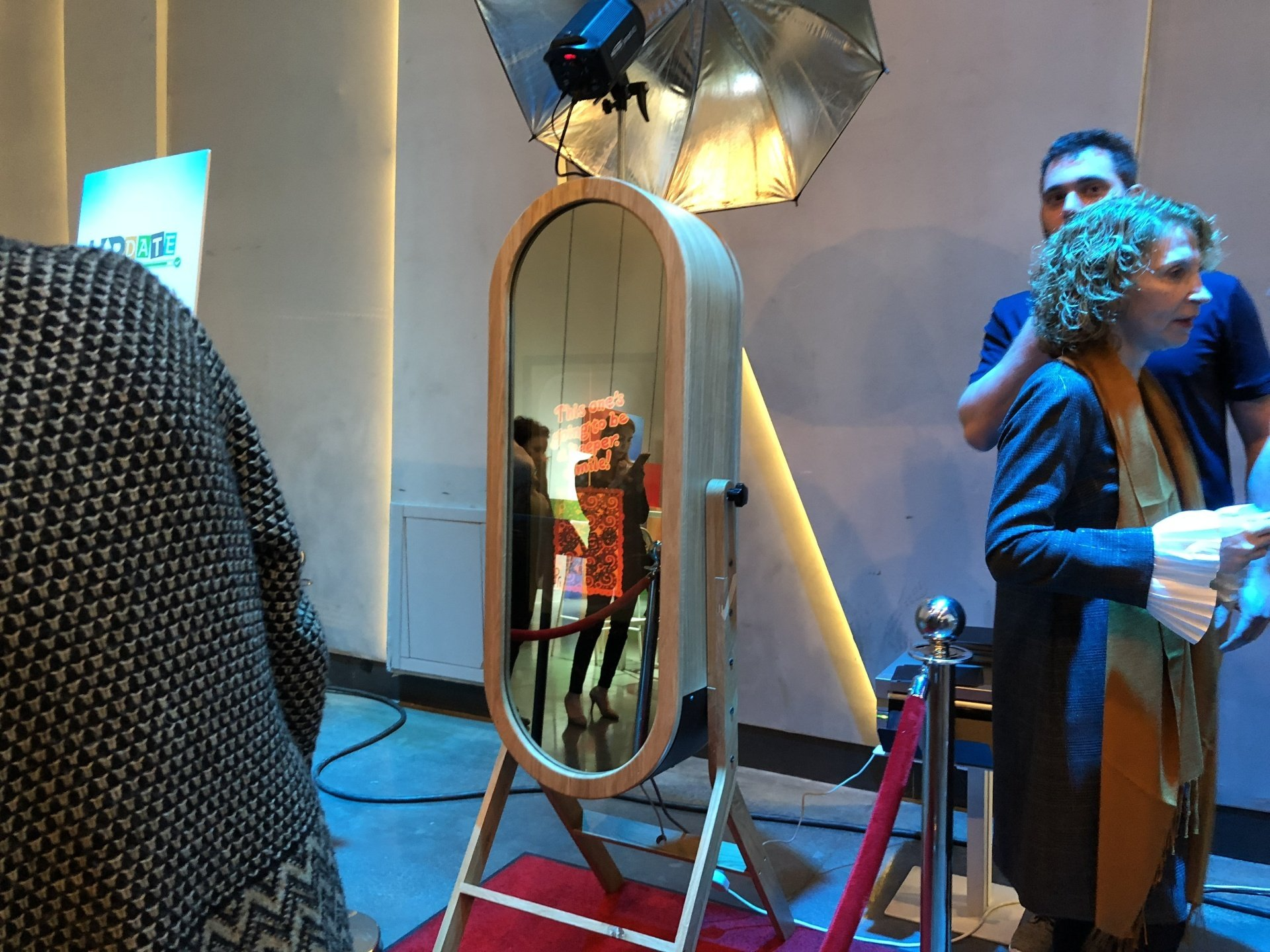 A woman is taking a picture in front of a mirror