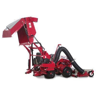 A red industrial leaf collection mower with a large, elevated debris hopper and a wide vacuum hose attached.