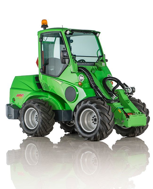 A bright green compact Avant articulated loader parked on a white background with a reflection underneath.