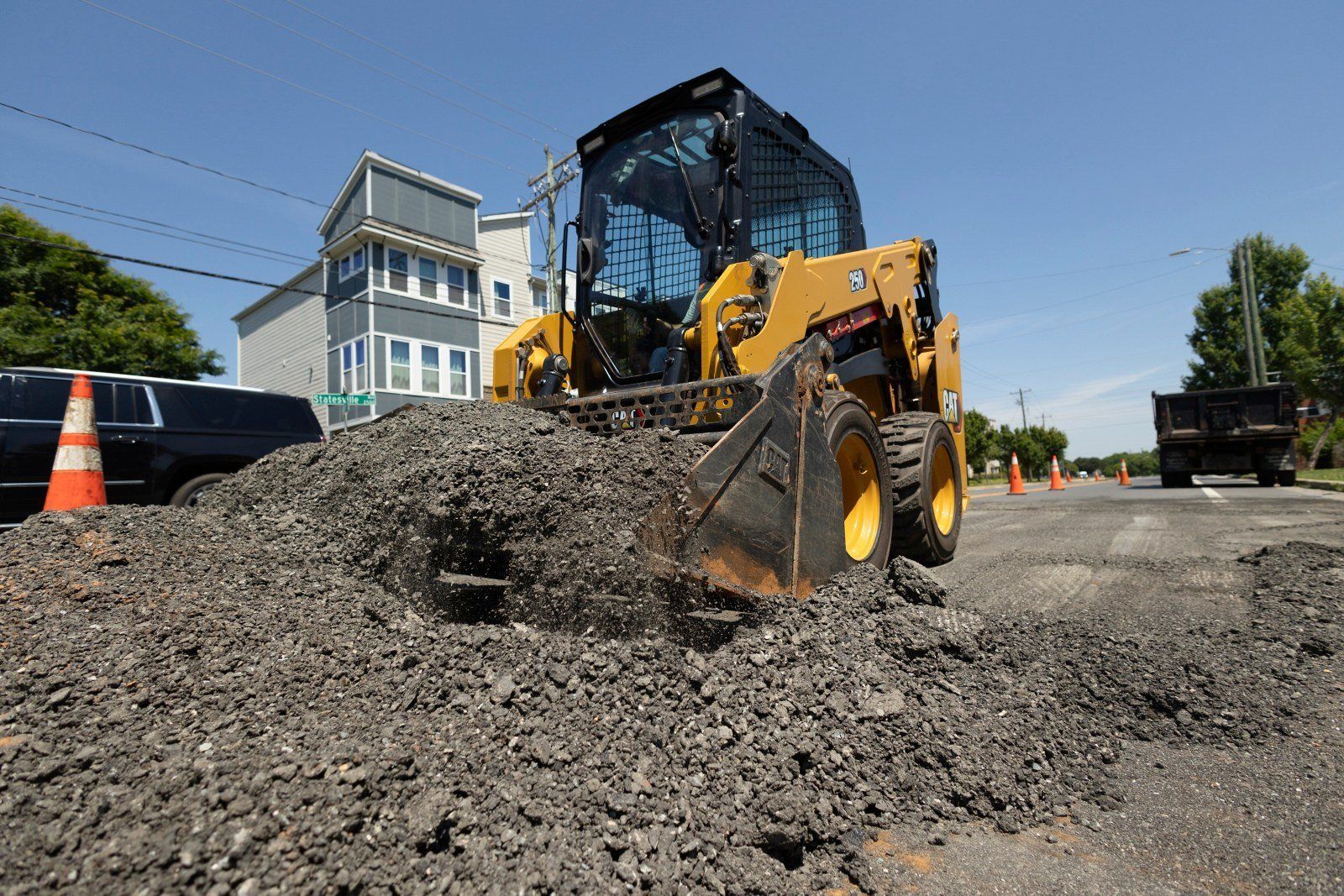 Cat 250 skid steer loader on a street job — Flex Equipment Rental
