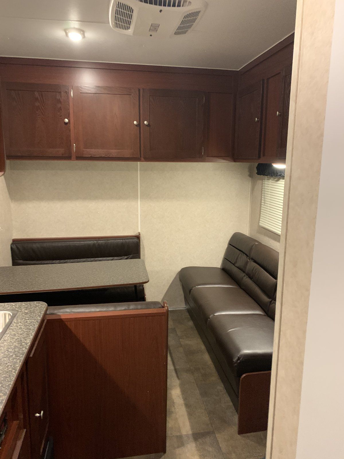 Crew room with dinette and sofa in the Vintage Outlaw RVT work trailer