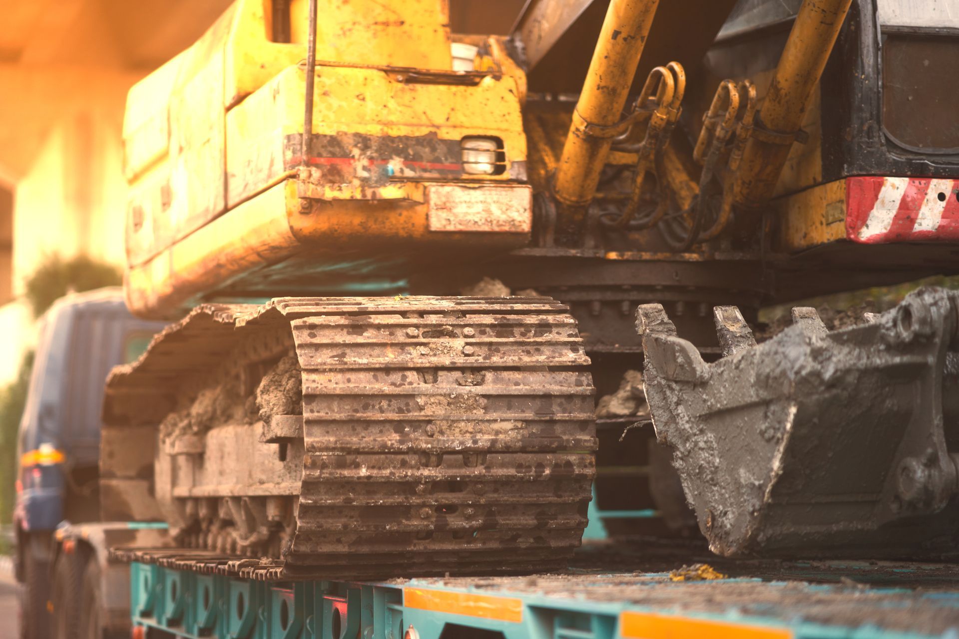 Excavator track and bucket loaded for heavy equipment transport and repair