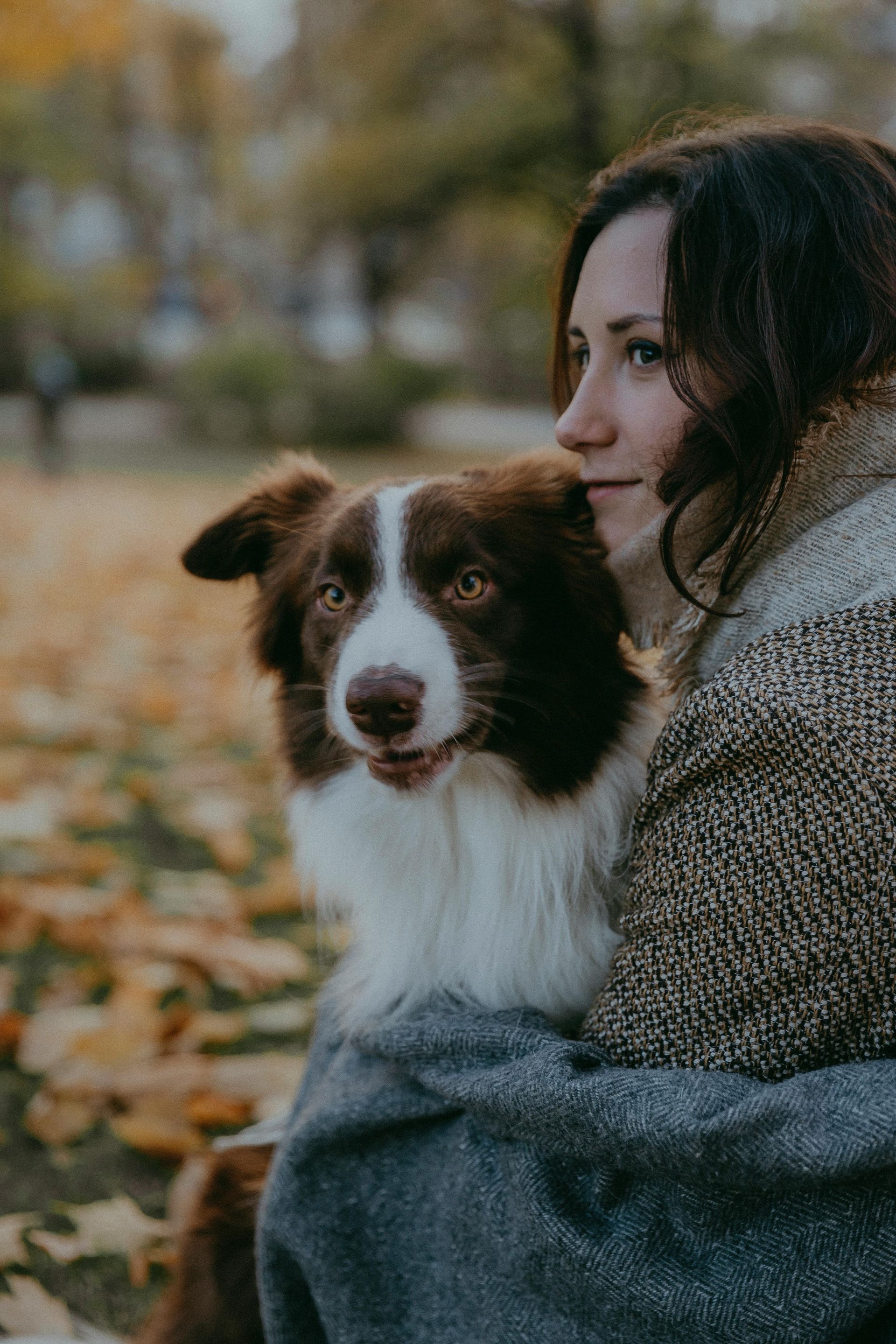 A person holding a dog