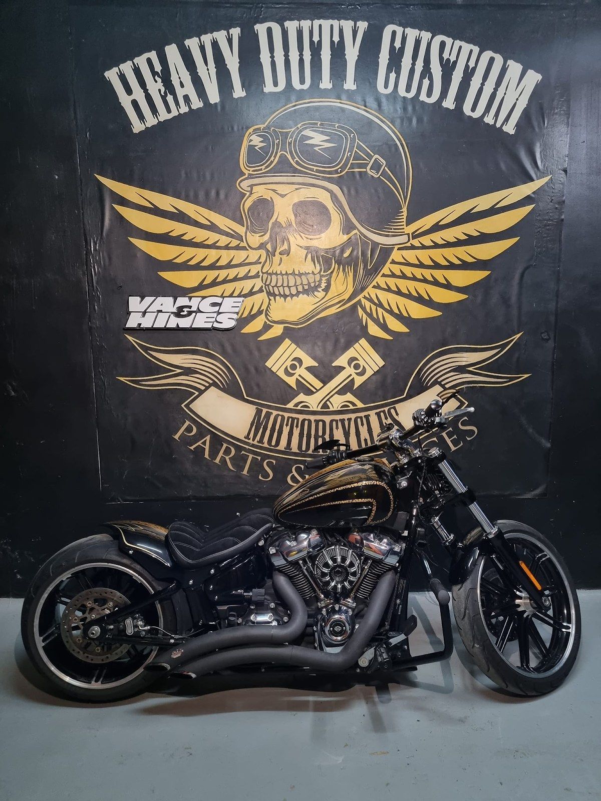 a motorcycle is parked on a wooden floor in a room .