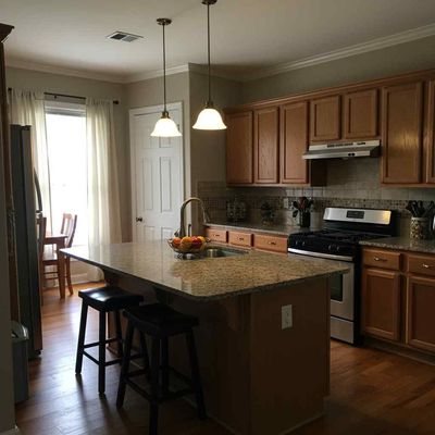 A kitchen with wooden cabinets and granite counter tops
