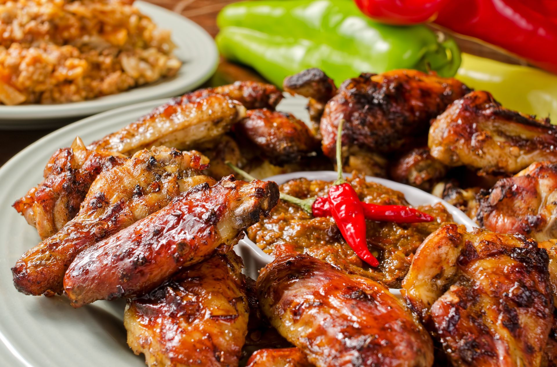 Buffalo chicken salad in a black bowl, with white dressing drizzled on top.