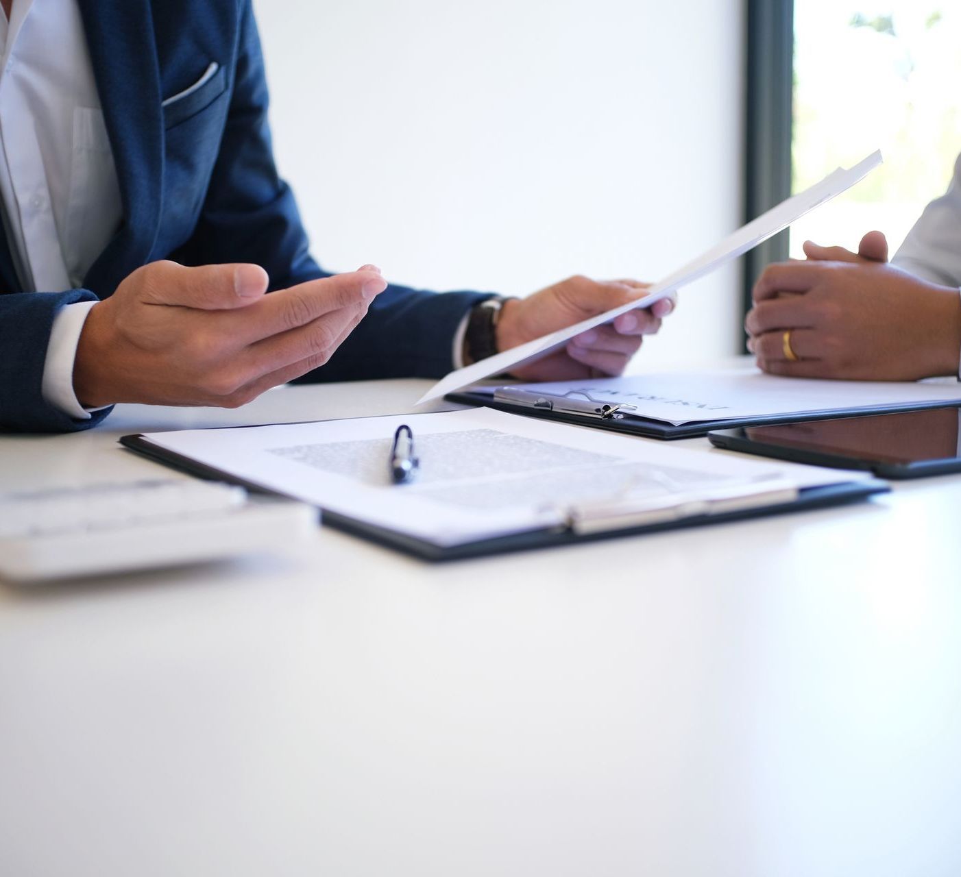 A man and a woman are sitting at a table looking at a piece of paper.