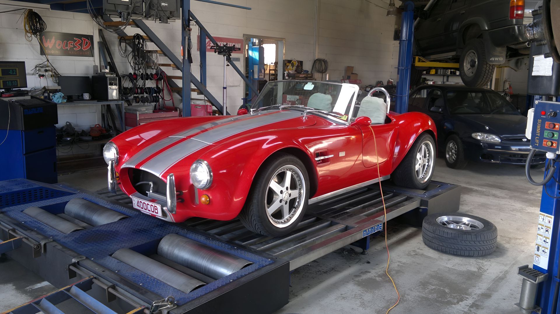 Red Sports Car on a Dynamometer in a Garage — EFI Evolutions Mechanical Repairs in Coffs Harbour, NSW
