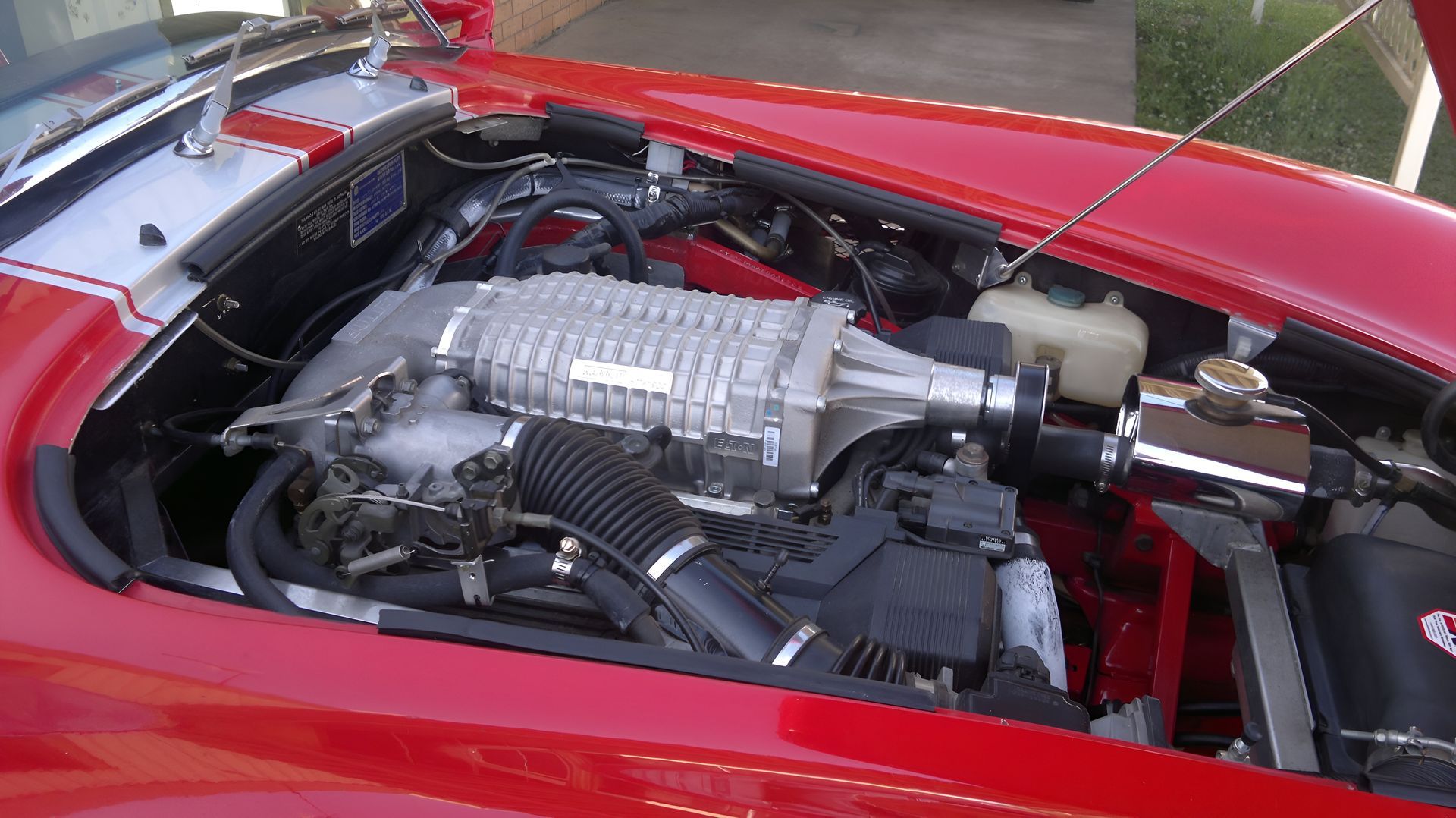 Red Car Engine Compartment, Featuring a Supercharger and Air Intake — EFI Evolutions Mechanical Repairs in Coffs Harbour, NSW