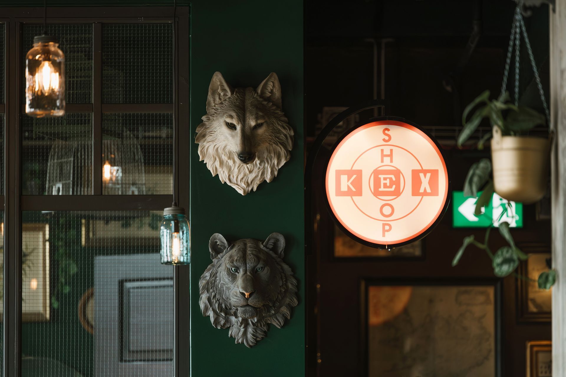 Green wall with wolf and bear head wall art, a