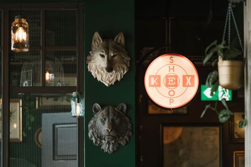 Green wall with animal head sculptures, a 