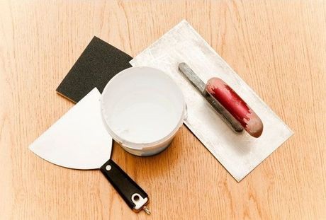 Drywall repair tools sitting on a handy worker work desk.