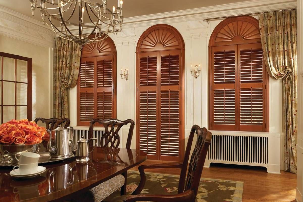 Brown Newstyle® Composite shutters installed in an elegant dining room at Curtain Concepts near Huntington, West Virginia