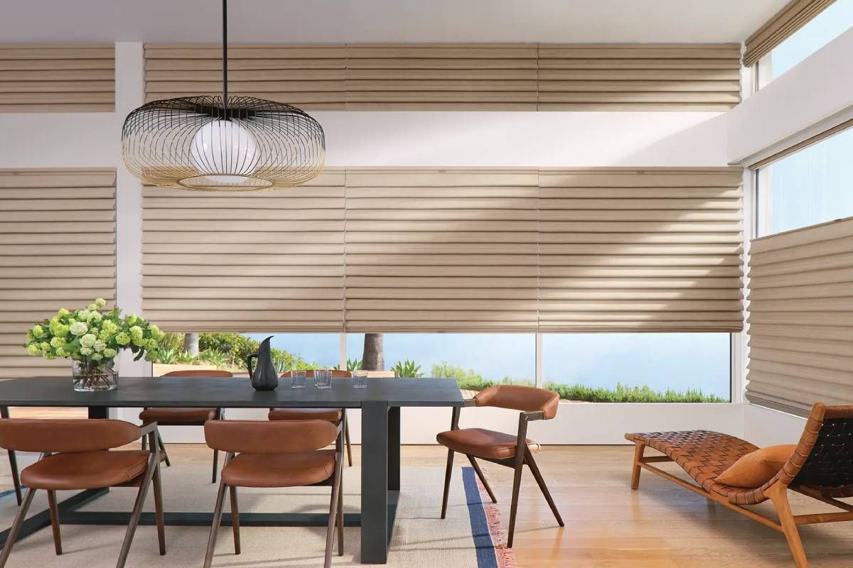 Custom Hunter Douglas Roman shades on expansive windows in a chic dining area of a home