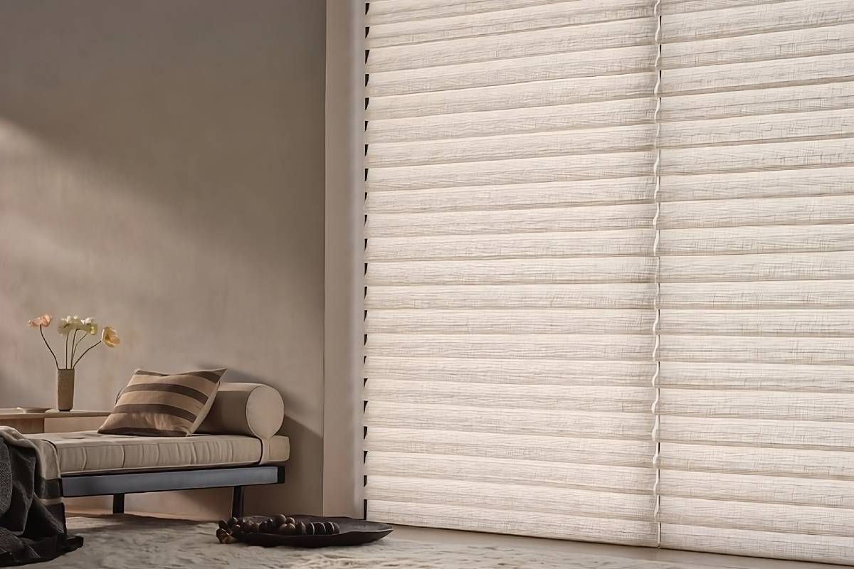 Energy-efficient Hunter Douglas Vignette® Roman Shades on a tall window in a neutral-themed living room at Curtain Concepts near Huntington, WV