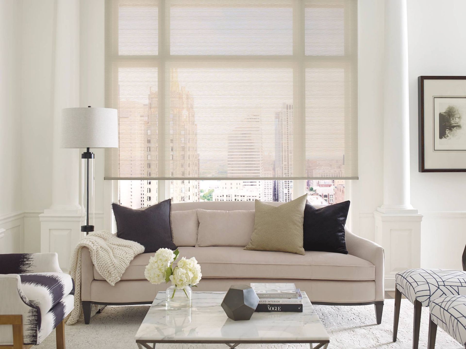 Hunter Douglas Alustra® Woven Textures® Roller Shades on a window in a chic living room