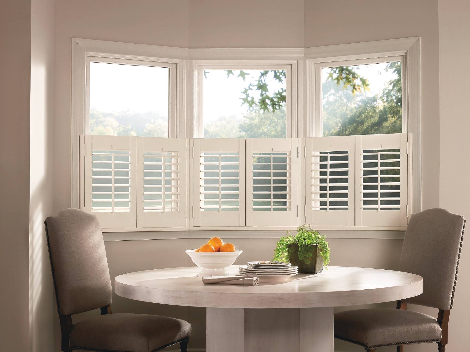 Hunter Douglas custom window shutters in a cafe-style on windows in a breakfast nook