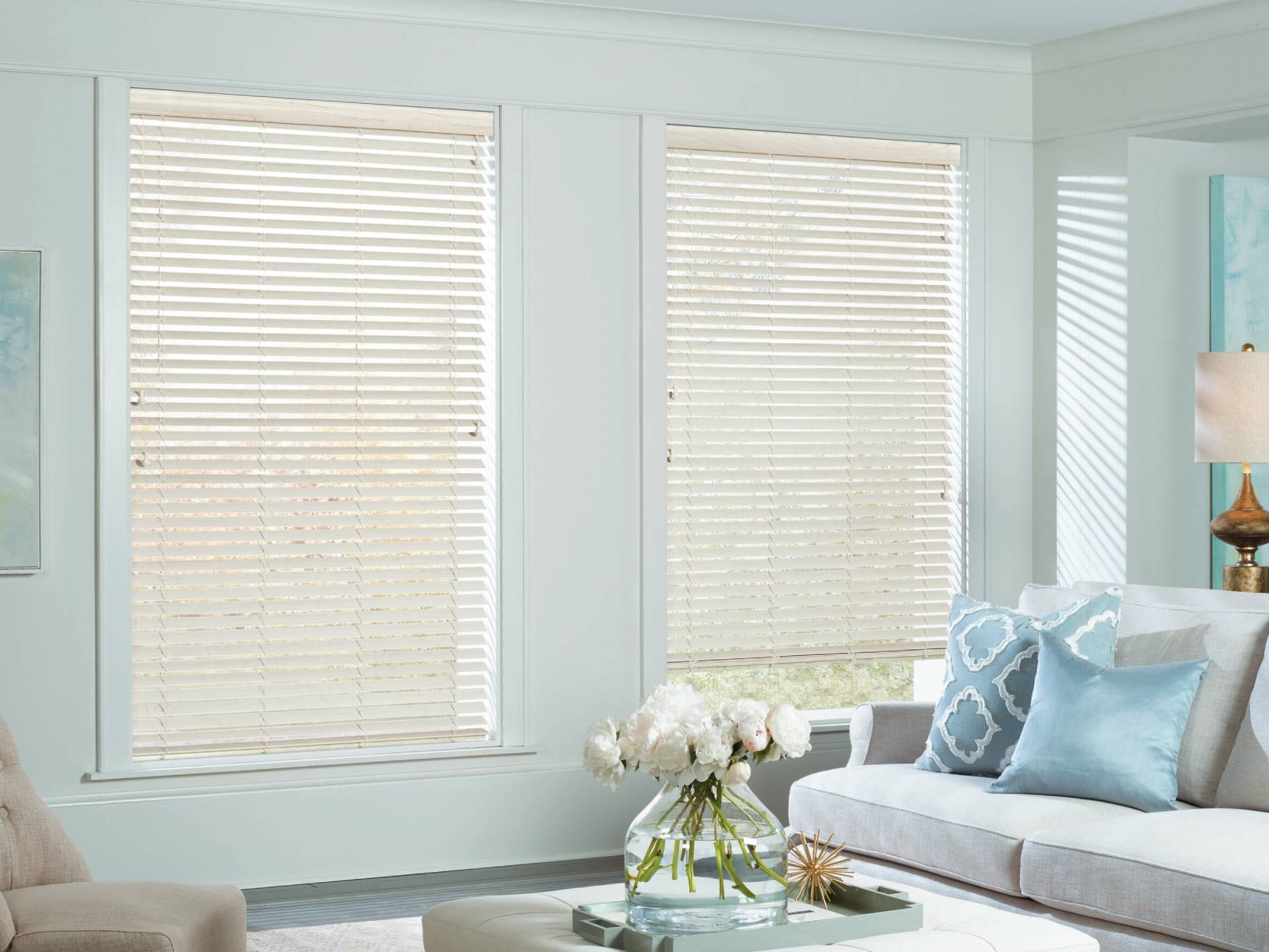 Hunter Douglas EverWood® Faux Wood Blinds on two windows in a bright and airy living room