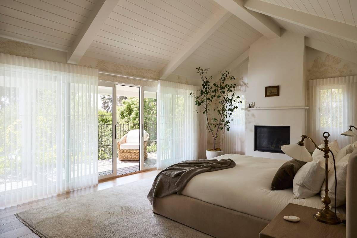 Hunter Douglas Luminette® Sheer Panels in a gorgeous bedroom, covering sliding glass doors and windows