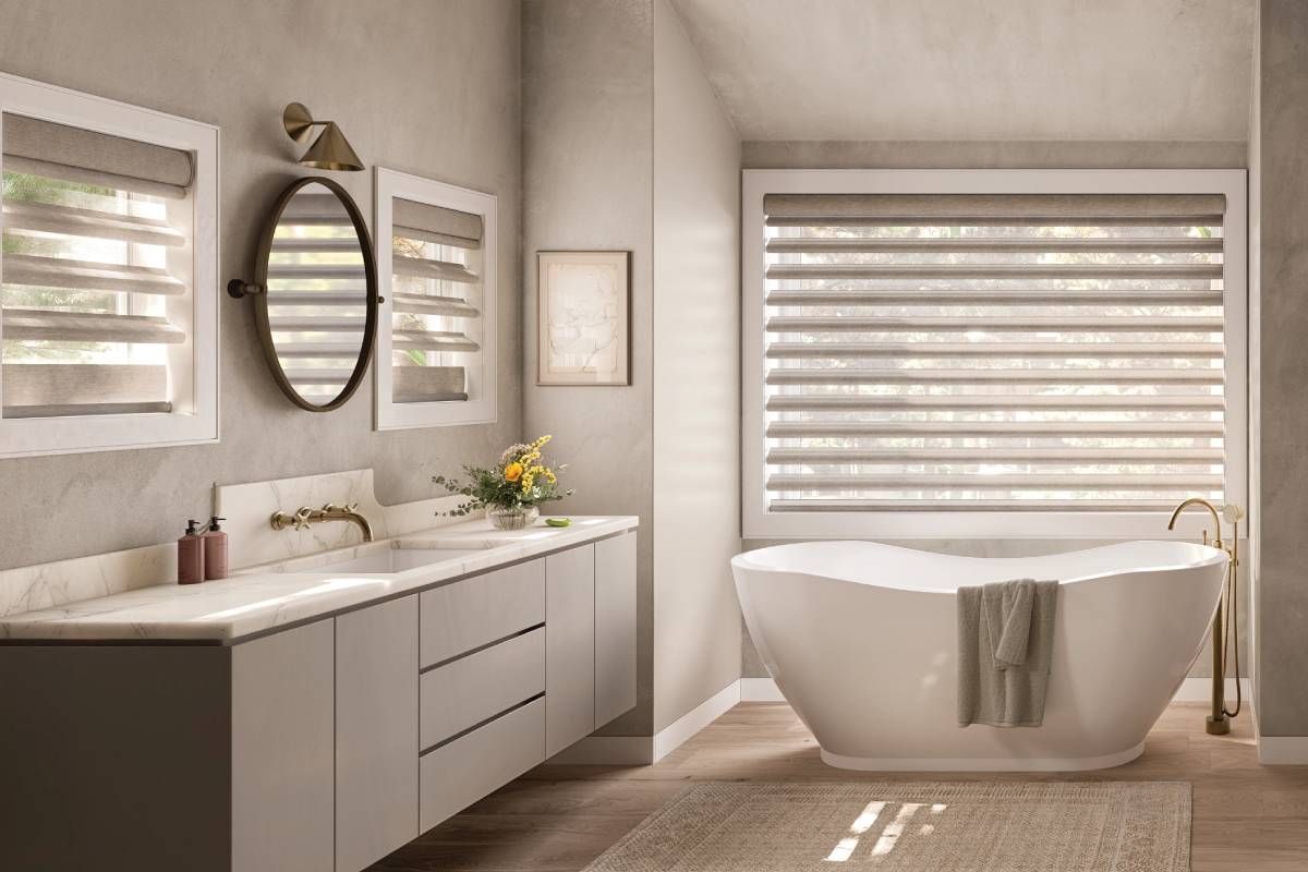 Hunter Douglas Pirouette® Sheer Shades on three windows in a luxurious bathroom near a soaking tub