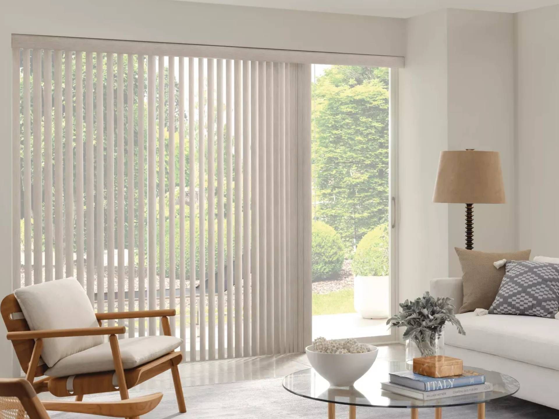 Hunter Douglas vertical blinds on a window and sliding door in a bright sitting room