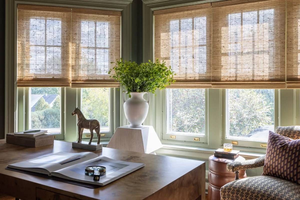 Provenance® Woven Wood Shades on several windows in a moody home office space