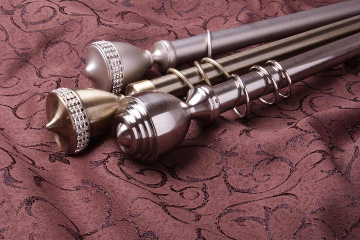 Several Drapery rods laying on a table