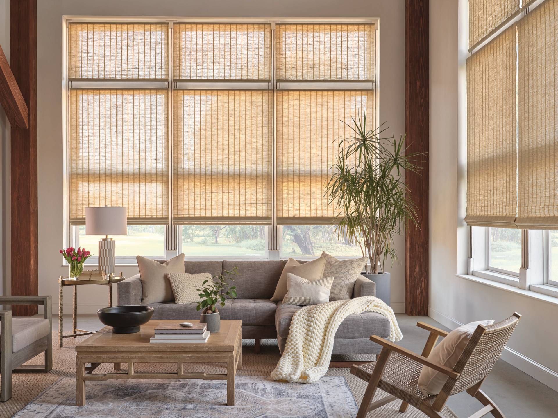 Stunning Hunter Douglas woven shades on tall and large windows in a stylish living room