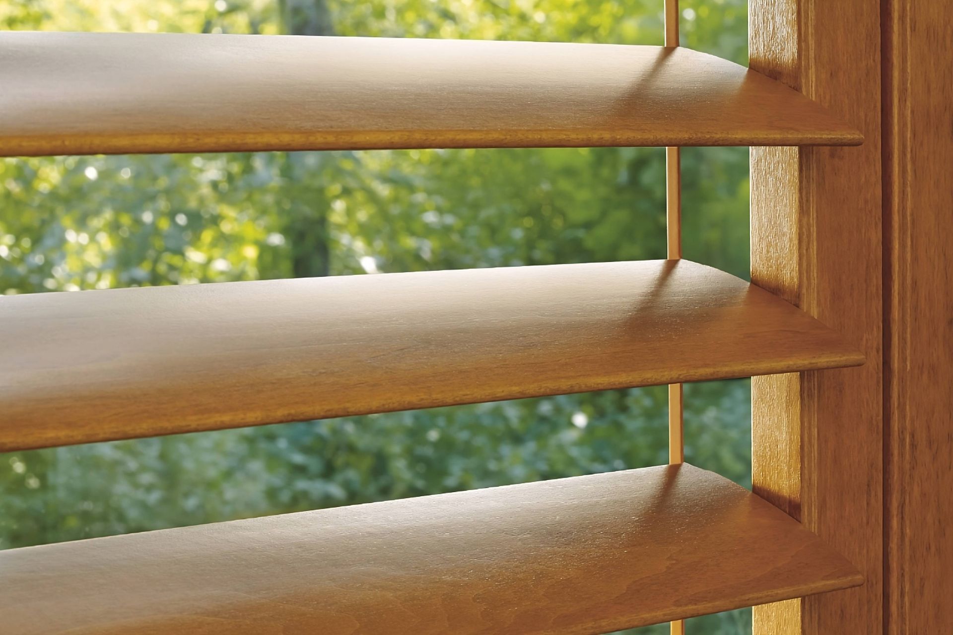 Up-close image of Hunter Douglas Heritance® Wood Shutters partially opened with a view outside, over