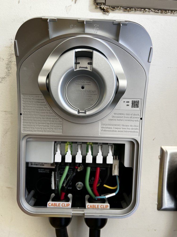 Open electrical panel with circuit breakers and visible wiring inside a metal box