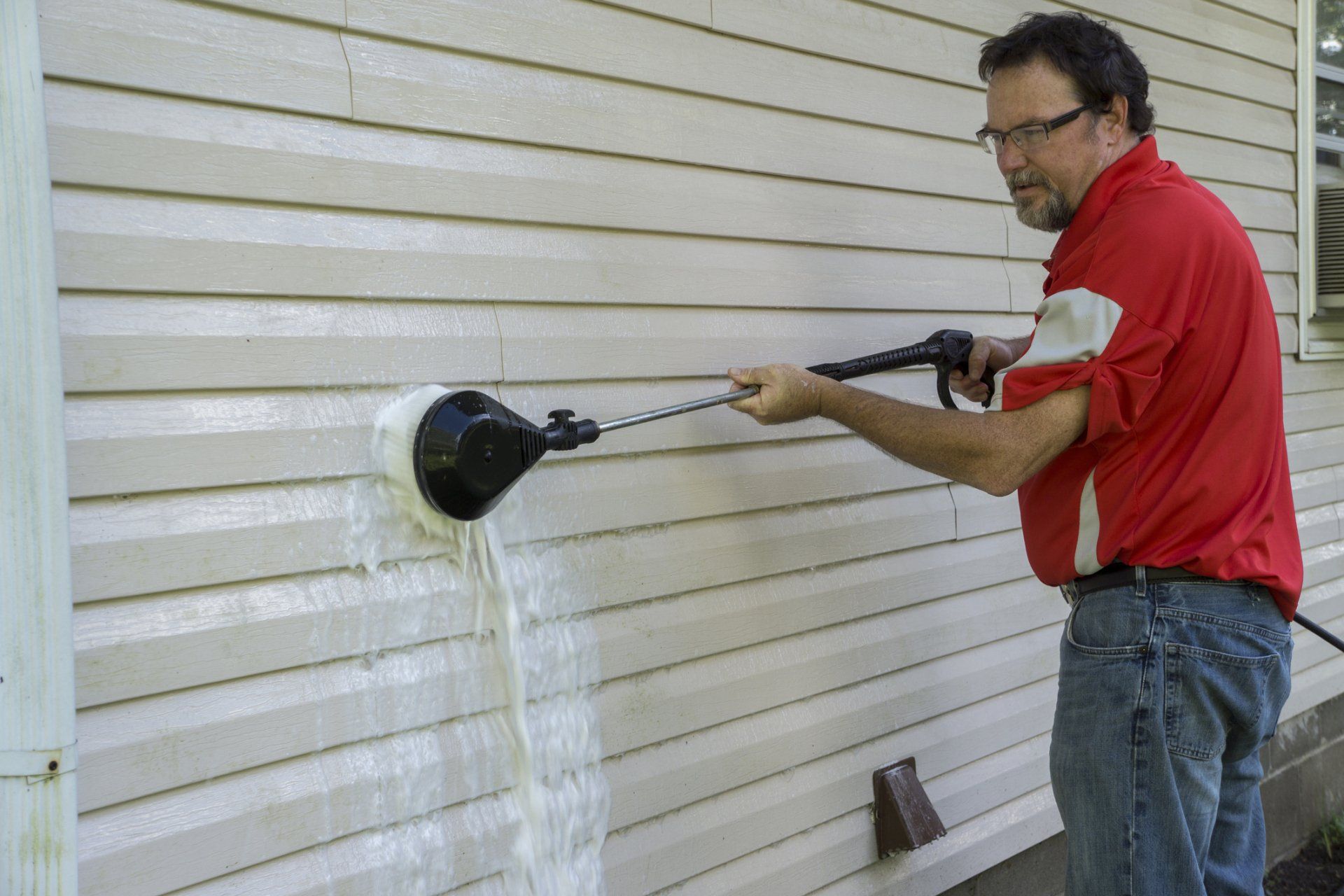 Man Using High-Pressure Brush to Remove Algae and Mold — Garfield, GA — Southeast Soft Wash Solutions Man Using High-Pressure Brush to Remove Algae and Mold — Garfield, GA — Southeast Soft Wash Solutions