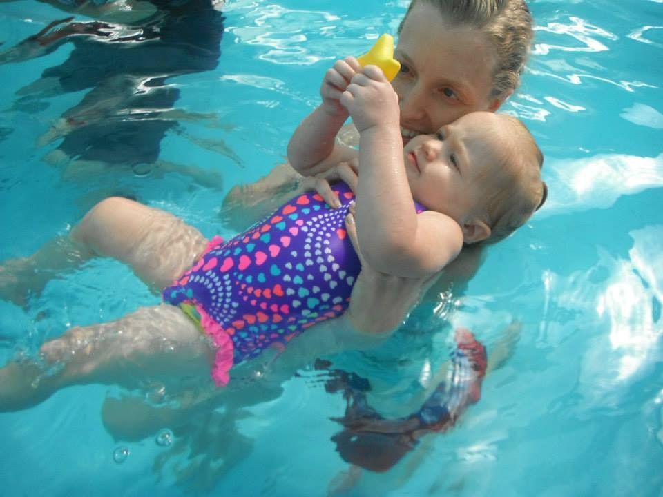 A Woman is Holding a Baby in a Swimming Pool — Affinity Swim in Norman Gardens, NSW