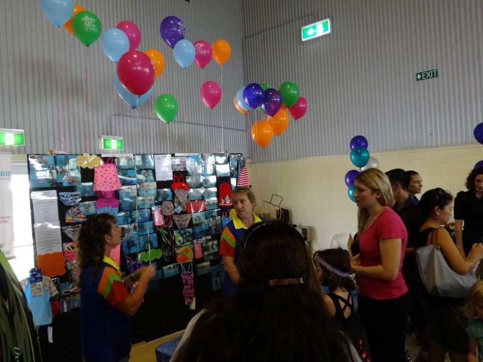 A Group of People Are Standing in a Room With Balloons Hanging From the Ceiling — Affinity Swim in Norman Gardens, NSW