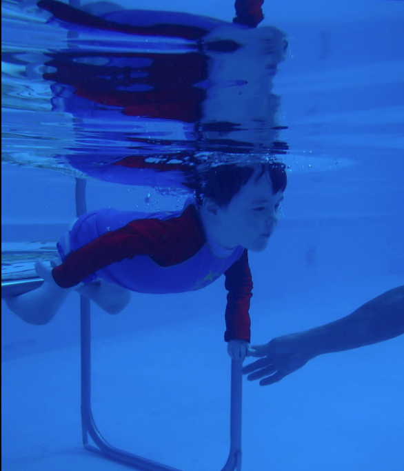 A Young Boy is Floating on a Boogie Board in a Swimming Pool — Affinity Swim in Norman Gardens, NSW