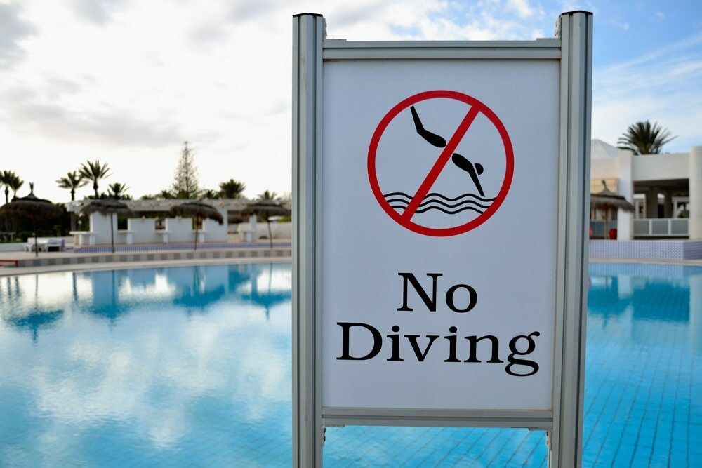 A Sign That Says No Diving in Front of a Swimming Pool — Affinity Swim in Norman Gardens, NSW