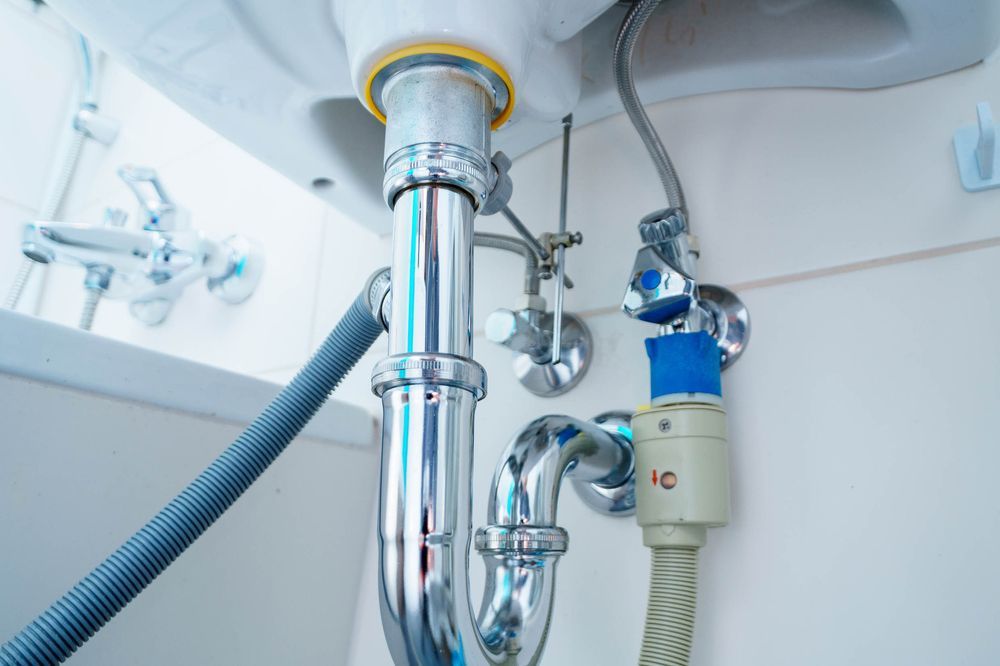 A Bathroom Sink With a Hose Attached to It — Northern Plumbing In Mount Louisa, QLD