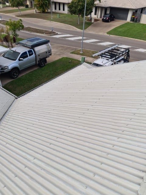 A White Truck is Parked on the Side of the Road Next to a White Roof — Northern Plumbing In Mount Louisa, QLD