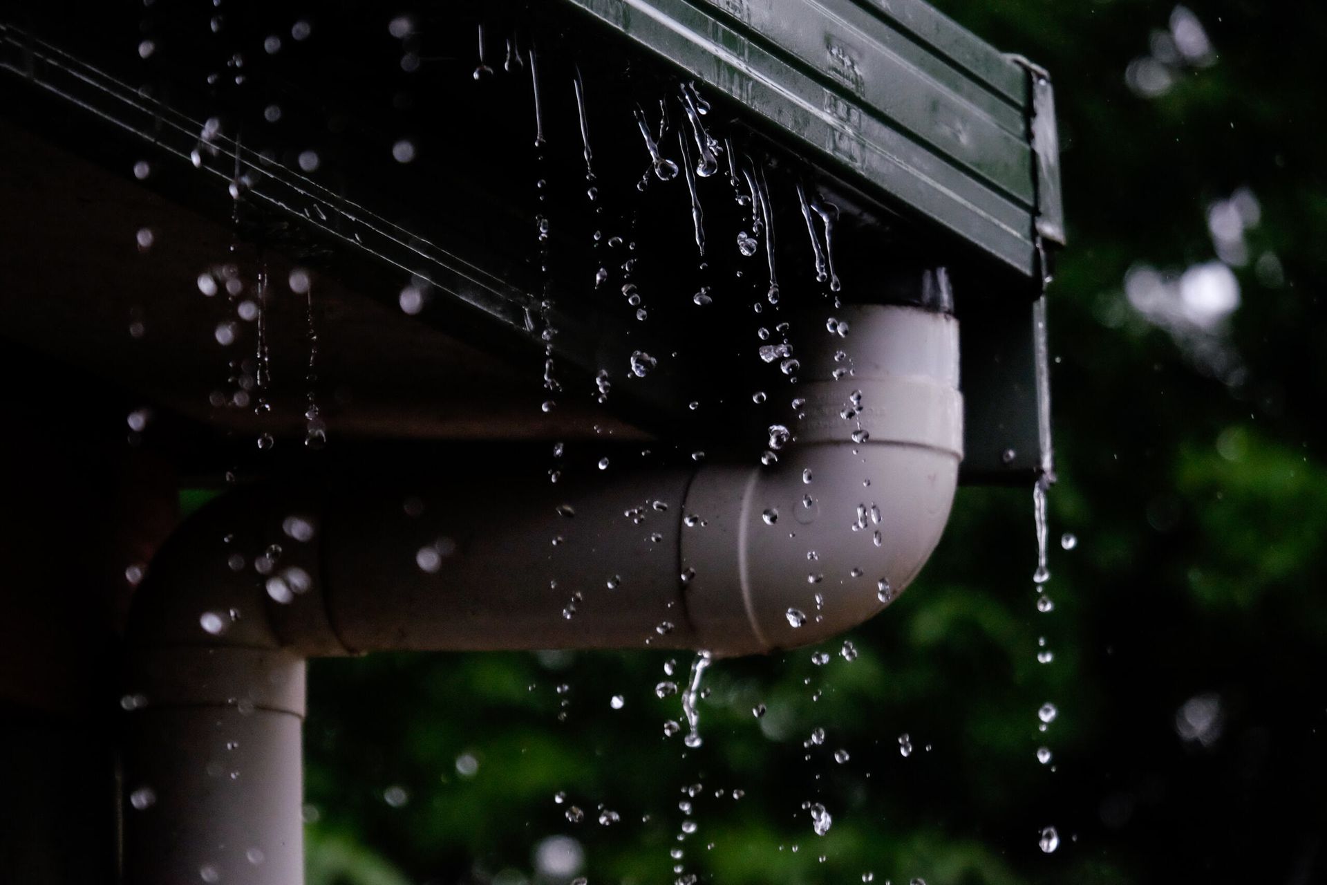 Rain is Falling From the Gutter of a House — Northern Plumbing In Mount Louisa, QLD